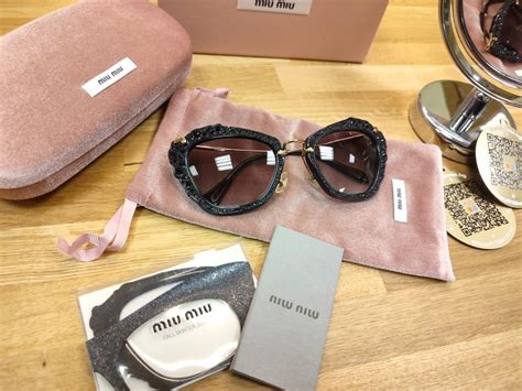 miu miu mu04qs 1ab0a7|Miu Miu MU04QS 1AB0A7 Sunglasses in Black.